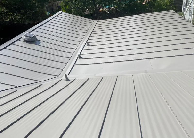 Solar attic fan installed on a metal roof for Roof Ventilation in Manhattan